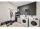 Functional laundry room with a washer, a dryer, and a dark accent wall at 615 N Church Ave, Fort Meade, FL 33841