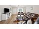 Comfortable living room featuring hardwood floors, a ceiling fan, and modern decor at 615 N Church Ave, Fort Meade, FL 33841