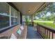 Cozy front porch features a comfortable wicker couch for relaxing at 615 N Church Ave, Fort Meade, FL 33841