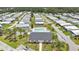 An expansive aerial perspective of the community buildings, swimming pool, and manicured green spaces at 6443 Hollyberry Ne Ln, Winter Haven, FL 33881