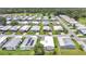 An attractive aerial view showcases the neat arrangement of homes with lush green lawns and mature trees at 6443 Hollyberry Ne Ln, Winter Haven, FL 33881