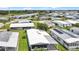A serene aerial perspective of well-maintained homes nestled in a tranquil neighborhood with mature trees and manicured lawns at 6443 Hollyberry Ne Ln, Winter Haven, FL 33881