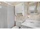 Bathroom featuring a toilet, vanity, framed mirror, and glass door shower with butterfly wallpaper at 6443 Hollyberry Ne Ln, Winter Haven, FL 33881