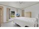 Bright bedroom featuring a comfortable bed, dresser, and a window offering an outside view at 6443 Hollyberry Ne Ln, Winter Haven, FL 33881