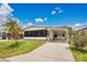 Charming single Gathering home with carport, well maintained lawn and colorful bushes at 6443 Hollyberry Ne Ln, Winter Haven, FL 33881