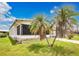 View of the side of a single Gathering home with well maintained lawn and palm trees at 6443 Hollyberry Ne Ln, Winter Haven, FL 33881