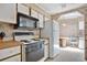 Practical kitchen featuring white appliances, wood countertops, and overhead microwave at 6443 Hollyberry Ne Ln, Winter Haven, FL 33881