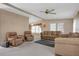 Comfortable living room offering a ceiling fan, neutral color scheme and multiple chairs at 6443 Hollyberry Ne Ln, Winter Haven, FL 33881
