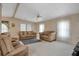 Cozy living room with neutral walls, carpet, ceiling fan, and multiple seating options at 6443 Hollyberry Ne Ln, Winter Haven, FL 33881