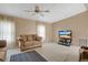 Bright living room featuring a ceiling fan, neutral walls, carpet and television at 6443 Hollyberry Ne Ln, Winter Haven, FL 33881
