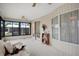 Bright sunroom with white walls, large windows and a sitting area with a comfy wicker couch at 6443 Hollyberry Ne Ln, Winter Haven, FL 33881