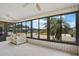 Bright sunroom with a wall of windows providing beautiful views of the surrounding landscape at 6443 Hollyberry Ne Ln, Winter Haven, FL 33881