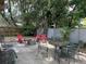 Cozy backyard fire pit area with ample seating and mature trees surrounding the space at 645 Avenue A Ne, Winter Haven, FL 33881