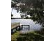 Scenic water view featuring a private dock and sparkling water, framed by lush trees at 645 Avenue A Ne, Winter Haven, FL 33881