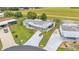 This aerial view showcases the home's long driveway, landscaping and proximity to a grassy field at 6509 Oak Hammock Ct, Winter Haven, FL 33884