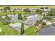 Aerial view of the community pool, shuffleboard, and a beautiful pond with lush greenery around the homes at 6509 Oak Hammock Ct, Winter Haven, FL 33884