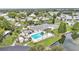 Aerial view of the community center, pool, shuffleboard courts, and well-maintained landscaping at 6509 Oak Hammock Ct, Winter Haven, FL 33884