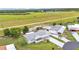 This aerial view shows the home's proximity to a green pasture, landscaping and neighborhood at 6509 Oak Hammock Ct, Winter Haven, FL 33884