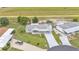 This aerial view highlights the home, landscaping, long driveway and serene location of the property at 6509 Oak Hammock Ct, Winter Haven, FL 33884