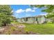 The side yard of this property has green grass, landscaping, a patio and room to roam at 6509 Oak Hammock Ct, Winter Haven, FL 33884