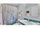 Clean bathroom featuring a shower-tub combo, white sink, and blue accents at 6509 Oak Hammock Ct, Winter Haven, FL 33884