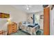 Bedroom features a double bed, ceiling fan, and wood-style dresser at 6509 Oak Hammock Ct, Winter Haven, FL 33884