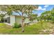 The side of this house has green grass, landscaping, a screened porch and a patio at 6509 Oak Hammock Ct, Winter Haven, FL 33884