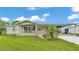Charming single-story home with a well-manicured lawn and carport at 6509 Oak Hammock Ct, Winter Haven, FL 33884