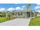 Inviting exterior of a single-story home with a lovely lawn and wide driveway at 6509 Oak Hammock Ct, Winter Haven, FL 33884