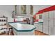 Bright kitchen featuring white cabinetry, tile countertops, and a breakfast bar at 6509 Oak Hammock Ct, Winter Haven, FL 33884