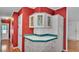 A charming kitchen boasts ample cabinet storage, unique glass-front upper cabinets and colorful accents at 6509 Oak Hammock Ct, Winter Haven, FL 33884