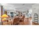 Spacious living room with hardwood floors and fireplace, open to kitchen at 6509 Oak Hammock Ct, Winter Haven, FL 33884