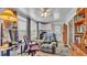 This cozy living room has a plush recliner, a work area, a ceiling fan and lots of natural light at 6509 Oak Hammock Ct, Winter Haven, FL 33884