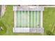Aerial view of shuffleboard courts with multiple lanes and overhead cover, surrounded by green lawns at 6509 Oak Hammock Ct, Winter Haven, FL 33884