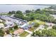 Aerial view of the community featuring mature landscaping, condos, and single Gathering homes by the lake at 686 22Nd Nw St, Winter Haven, FL 33880