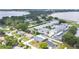 Aerial view of a lakeside community featuring condos, single Gathering homes and mature trees at 686 22Nd Nw St, Winter Haven, FL 33880