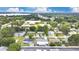 Community aerial view with mature trees and landscaping with lake views in the distance at 686 22Nd Nw St, Winter Haven, FL 33880