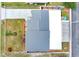 An aerial shot of the property showing the yard, patio, landscaping, roof, and neighborhood at 686 22Nd Nw St, Winter Haven, FL 33880