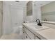 Traditional bathroom featuring a tub-shower combo, white vanity, and neutral tile at 686 22Nd Nw St, Winter Haven, FL 33880