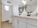 Bright bathroom featuring double sinks, sleek faucets, mirrors, and a glass-enclosed shower at 686 22Nd Nw St, Winter Haven, FL 33880