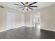 Open concept bedroom with wood-look tile flooring and ceiling fan at 686 22Nd Nw St, Winter Haven, FL 33880