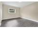 An empty bedroom featuring wood-look floors, neutral-colored walls, and a window bringing in natural light at 686 22Nd Nw St, Winter Haven, FL 33880
