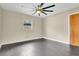 Bedroom featuring wood-look tile flooring, ceiling fan and a window at 686 22Nd Nw St, Winter Haven, FL 33880