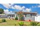 The home features newly installed windows, attractive landscaping, and gray siding with black trim at 686 22Nd Nw St, Winter Haven, FL 33880