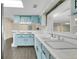 Light and airy kitchen showcasing blue cabinets and a convenient breakfast bar at 686 22Nd Nw St, Winter Haven, FL 33880