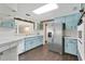 Bright kitchen with stainless steel appliances, including a large refrigerator, and light blue cabinets at 686 22Nd Nw St, Winter Haven, FL 33880