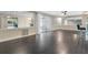 Open concept living room with wood-look tile, ceiling fan, and sliding glass door at 686 22Nd Nw St, Winter Haven, FL 33880