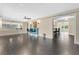 Spacious living room with a sleek wet bar, ceiling fan, and wood-look tile flooring at 686 22Nd Nw St, Winter Haven, FL 33880