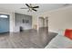 Open-concept living room featuring an accent brick wall, wood floors, and natural light at 686 22Nd Nw St, Winter Haven, FL 33880