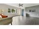 Bright living room with an accent brick wall, stylish wood floors, and natural light at 686 22Nd Nw St, Winter Haven, FL 33880